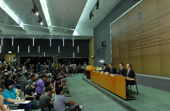 Mr Leung (third right) responses to a question at the press conference.