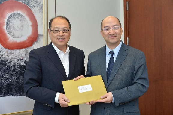 Mr Tam (right) receives Dr Lam''s submission on constitutional development.