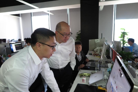 Mr Tam (right) is briefed on the operation of a start-up company in Zhongguancun.
