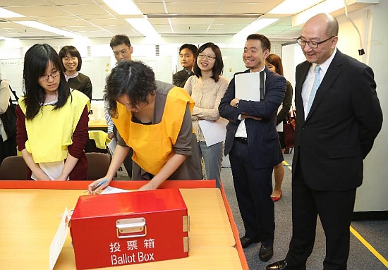 The Secretary for Constitutional and Mainland Affairs, Mr Raymond Tam, visited the Registration and Electoral Office today (May 31). Photo shows Mr Tam (first right) being briefed on vote counting procedures.