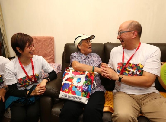 The Secretary for Constitutional and Mainland Affairs, Mr Raymond Tam (right), accompanied by the District Officer (Yau Tsim Mong), Mrs Laura Aron (left), visits an elderly in Yau Tsim Mong District today (June 17) to learn about her life and distribute gift packs to her.