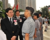 Photograph shows Mr Lam speaking to a uniform group member when inspecting the uniform groups.