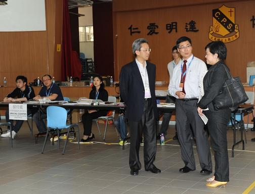 The Permanent Secretary for Constitutional and Mainland Affairs, Mr Joshua Law (first from left), visited a Legislative Council by-election polling station set up at the Tai Kok Tsui Catholic Primary School this afternoon (May 16).