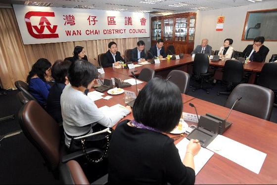 Photo shows Mr Lam exchanging views with Wan Chai District Council (DC) Members at the DC's conference room.