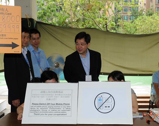 The Secretary for Constitutional and Mainland Affairs, Mr Stephen Lam, visits the polling station for the Yuen Long District Council Shap Pat Heung North Constituency by-election set up at the Buddhist Wing Yan School, Fung Yau Street South, Yuen Long, this morning (June 26). Photo shows Mr Lam chatting with polling station officers.