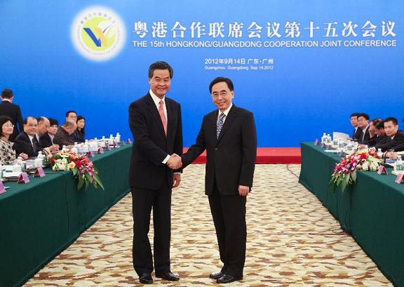 Mr Leung (left) shakes hands with Mr Zhu (right) prior to the plenary.