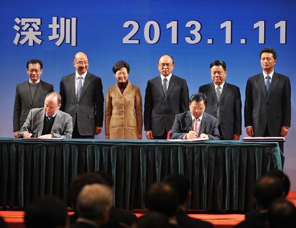 Mrs Lam (back row, third left) and Mr Xu (back row, fourth left) witness the signing of co-operation agreements between Hong Kong and Shenzhen.