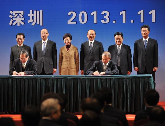Mrs Lam (back row, third left) and Mr Xu (back row, fourth left) witness the signing of co-operation agreements between Hong Kong and Shenzhen.