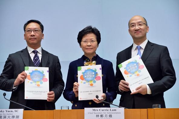 Mrs Lam (centre), joined by Mr Yuen (left) and Mr Tam (right), held a press conference on the "Consultation Document on the Methods for Selecting the Chief Executive in 2017 and for Forming the Legislative Council in 2016". Picture shows the officials displaying the consultation document.