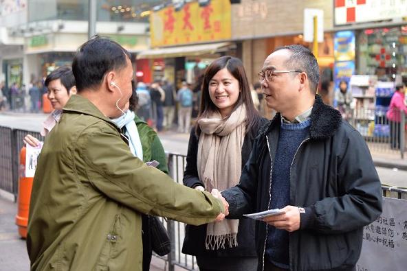 政制及內地事務局副局長劉江華（右一）在香港仔向市民派發諮詢文件宣傳單張。
