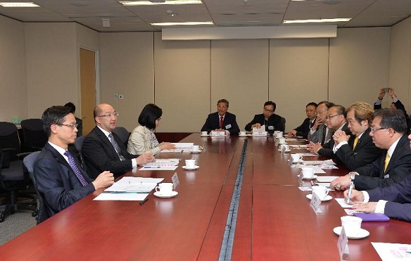 The Secretary for Constitutional and Mainland Affairs, Mr Raymond Tam (second left), and the Under Secretary for Commerce and Economic Development, Mr Godfrey Leung (first left), meet with the Hong Kong General Chamber of Small and Medium Business (HKGCSMB) as well as other representatives of small and medium-sized enterprises in Hong Kong to exchange views with participants on the "Consultation Document on the Methods for Selecting the Chief Executive in 2017 and for Forming the Legislative Council in 2016" this afternoon (April 9).