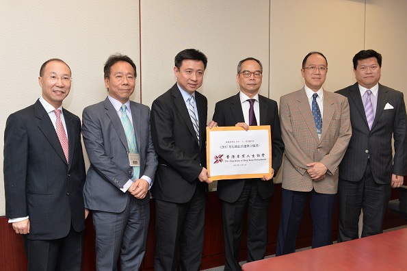 Mr Lau (third right) receives the Association of Hong Kong Professionals'' submission on constitutional development.