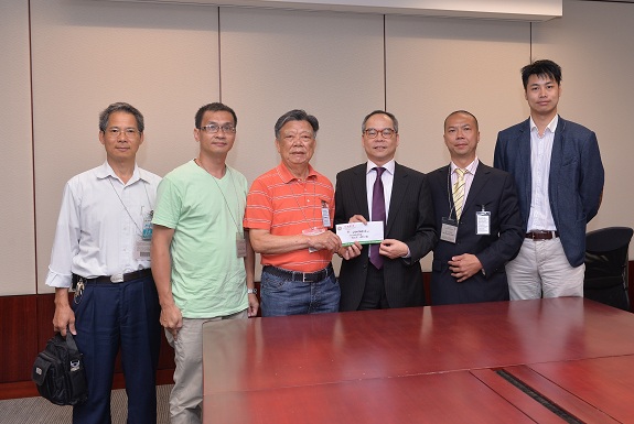 Mr Lau (third right) receives the Yuen Long Merchants Association''s submission on constitutional development.