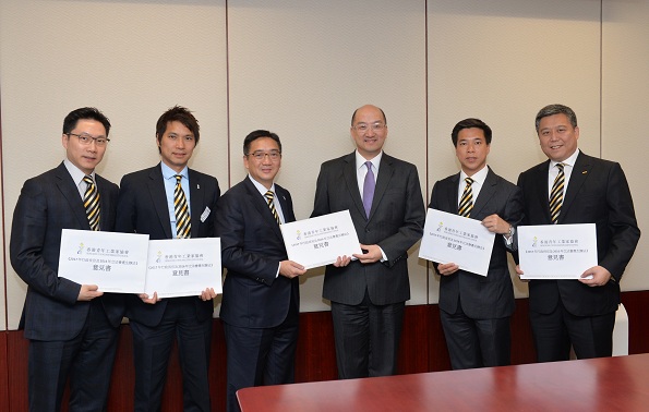 Mr Tam (third right) receives submissions on constitutional development from the Hong Kong Young Industrialists Council.