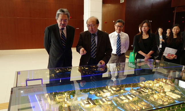 Mr Tsang (first left) is briefed by the Rector of the University of Macau, Professor Zhao Wei (second left), on the new campus of the University of Macau on Hengqin Island.