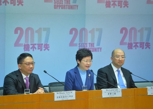 Mrs Lam (centre) responds to a question at the press conference.