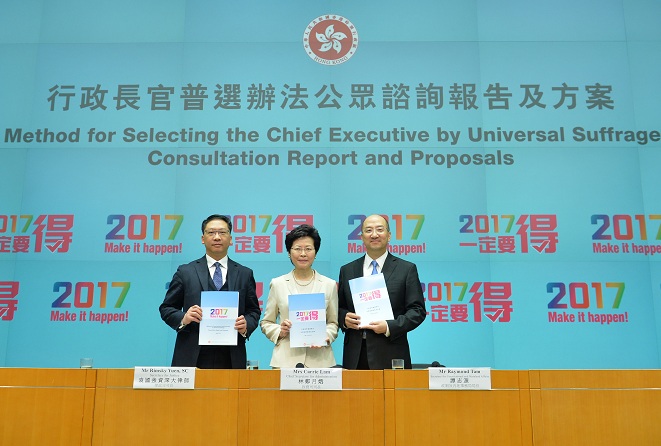 The Chief Secretary for Administration, Mrs Carrie Lam (centre); the Secretary for Justice, Mr Rimsky Yuen, SC (left); and the Secretary for Constitutional and Mainland Affairs, Mr Raymond Tam (right), hold a press conference on the Consultation Report and Proposals on the Method for Selecting the Chief Executive by Universal Suffrage at the Central Government Offices this afternoon (April 22).