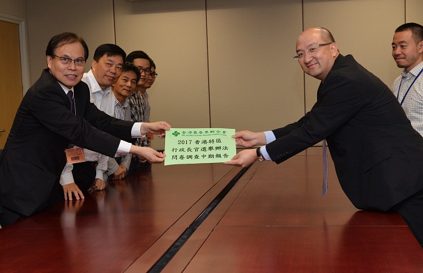 The Secretary for Constitutional and Mainland Affairs, Mr Raymond Tam, today (May 18) met with representatives of the Hong Kong Island Federation and listened to their briefing on the results of a survey the Federation conducted on the proposals on the method for selecting the Chief Executive by universal suffrage in 2017. Photo shows a representative of the Federation submitting the survey results to Mr Tam (second right).