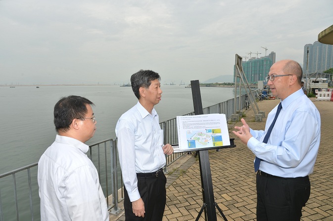 Mr Tam (first right) is briefed by a Planning Department officer on the topside development of the Hong Kong Boundary Crossing Facilities Island of the Hong Kong-Zhuhai-Macao Bridge.