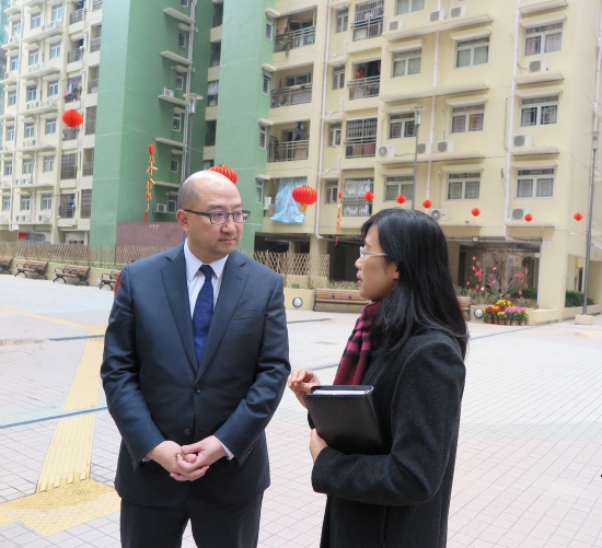 Mr Tam (left) visits a public housing project to learn about Macau's latest housing developments.