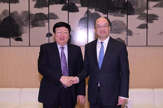 Mr Tam (right) and Mr Chen shake hands before the meeting.