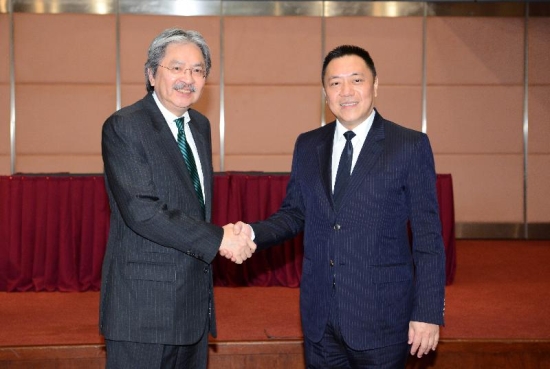 The Financial Secretary, Mr John C Tsang (left), shakes hands with the Secretary for Economy and Finance of the Macau Special Administrative Region, Mr Lionel Leong (right), before the Ninth Hong Kong Macao Co-operation High Level Meeting in Macau today (July 15).
