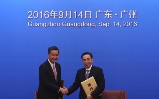 The Chief Executive, Mr C Y Leung, led the Hong Kong Special Administrative Region Government delegation to attend the 19th Plenary of the Hong Kong/Guangdong Co-operation Joint Conference in Guangzhou today (September 14). Photo shows Mr Leung (left) and the Governor of Guangdong Province, Mr Zhu Xiaodan (right), exchanging a signed agreement on co-operation between Hong Kong and Guangdong.