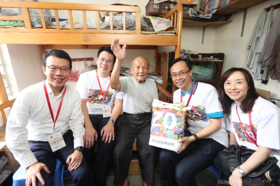 The Secretary for Constitutional and Mainland Affairs, Mr Patrick Nip (second right), accompanied by the Deputy Secretary for Constitutional and Mainland Affairs, Miss Charmaine Lee (first right), and the District Officer (Kwun Tong), Mr Steve Tse (second left), visits an elderly family in Kwun Tong District today (July 18) under the 