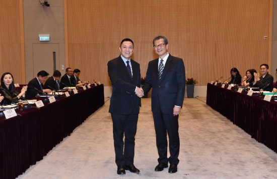 The Financial Secretary, Mr Paul Chan (right), shakes hands with the Secretary for Economy and Finance of the Macao Special Administrative Region, Mr Lionel Leong, before the 10th Hong Kong Macao Co-operation High Level Meeting in Hong Kong today (October 27).