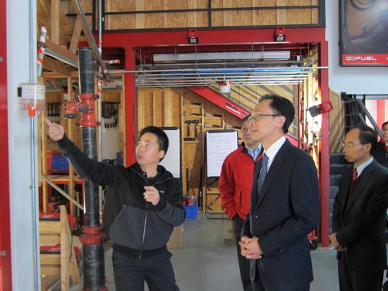 The Secretary for Constitutional and Mainland Affairs, Mr Patrick Nip, visited a Hong Kong power tool production company in Dongguan today (February 7). Photo shows Mr Nip (second right) being briefed on how engineers have modified and improved products at the company's training centre.