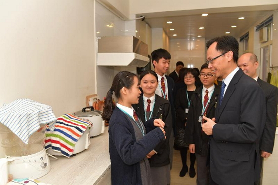 The Secretary for Constitutional and Mainland Affairs, Mr Patrick Nip (right), tours the facilities of Cotton Spinners Association Secondary School in Kwai Tsing District today (March 2).
