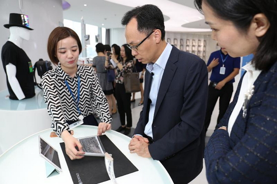 The Secretary for Constitutional and Mainland Affairs, Mr Patrick Nip, visited Shenzhen today (August 7). Photo shows Mr Nip (centre) being briefed by a representative of a company specialising in developing flexible display technology on one of the applications of the technology - a flexible keyboard.