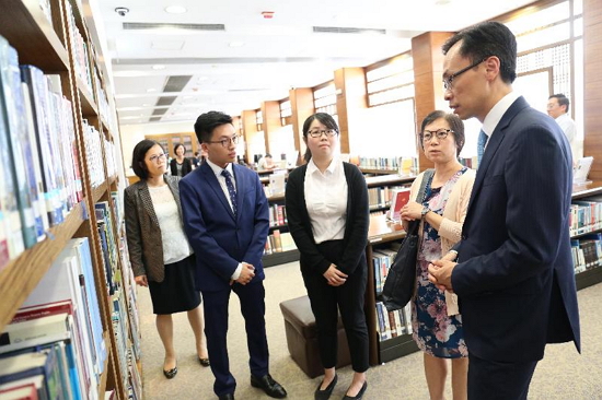 The Secretary for Constitutional and Mainland Affairs, Mr Patrick Nip, toured the Basic Law Library today (August 24). Picture shows Mr Nip (right) being briefed on the library facilities by a colleague of the Leisure and Cultural Services Department.