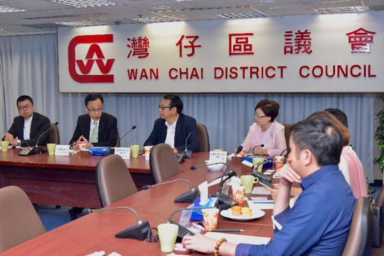 The Secretary for Constitutional and Mainland Affairs, Mr Patrick Nip (second left), meets with members of the Wan Chai District Council today (November 22) to exchange views on district and community affairs.