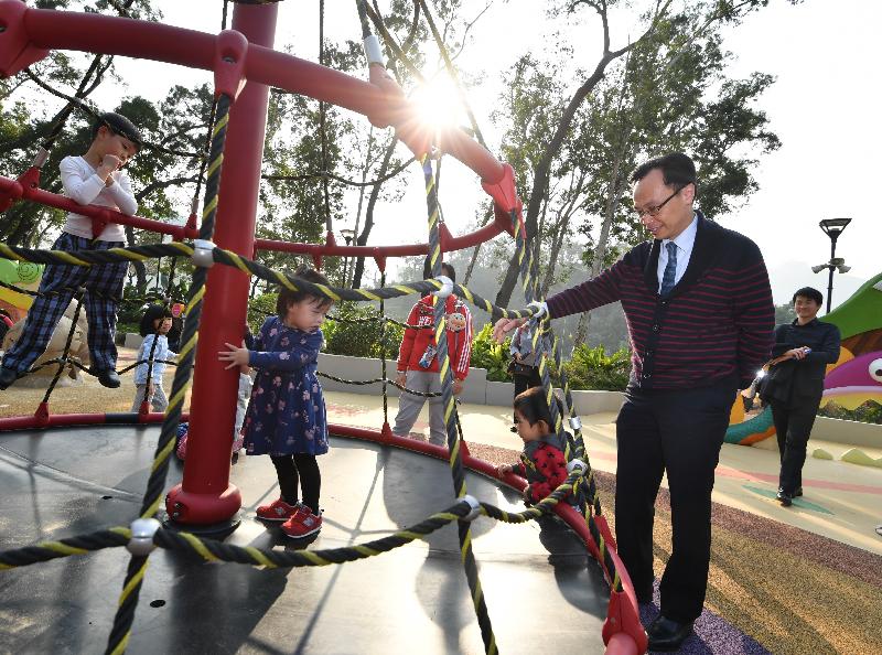 The Secretary for Constitutional and Mainland Affairs, Mr Patrick Nip (second right), visited an inclusive playground in Tuen Mun Park this afternoon (March 11). Photo shows him touring the playground facilities, which incorporate a barrier-free design. 
