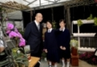 Mr Tam visits the green house in the school.